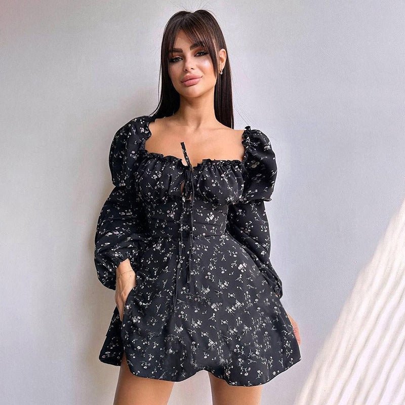 Chic black floral dress featuring long puff sleeves in a lifestyle setting, perfect for a capsule wardrobe.