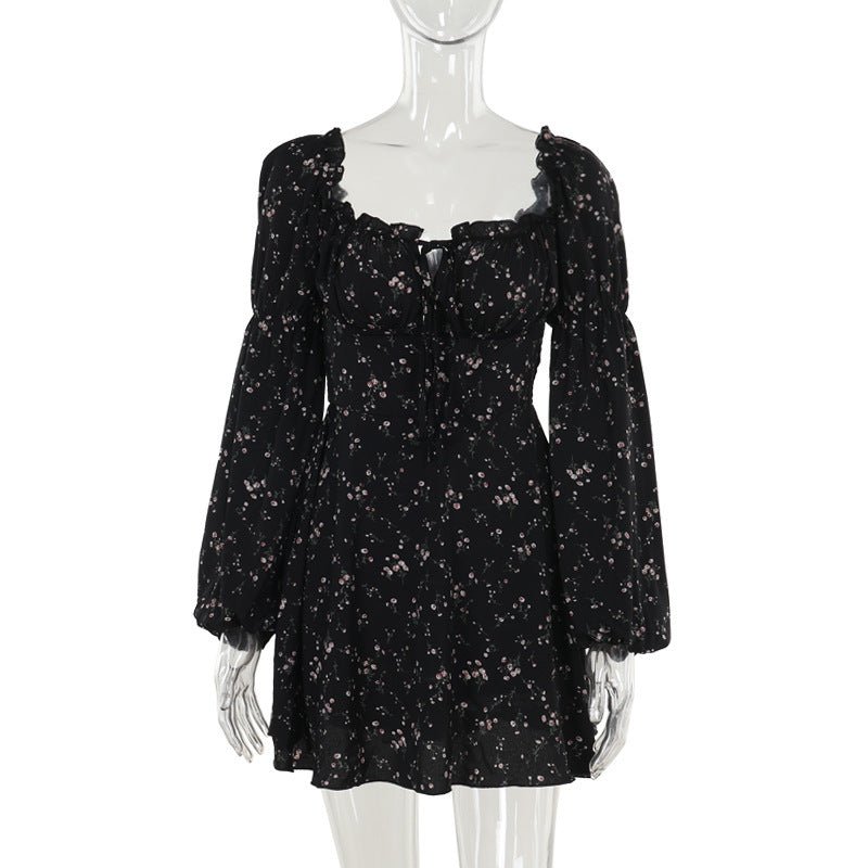 Elegant black floral dress with long puff sleeves in a lifestyle shot, ideal for minimalist fashion lovers.