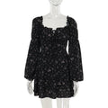 Elegant black floral dress with long puff sleeves in a lifestyle shot, ideal for minimalist fashion lovers.