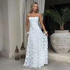 Lifestyle shot of the white backless chiffon slip dress, elegant design with flowy fabric in natural setting.