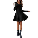 Front view of a black V-neck dress featuring long sleeves and flared skirt on a solid color background.