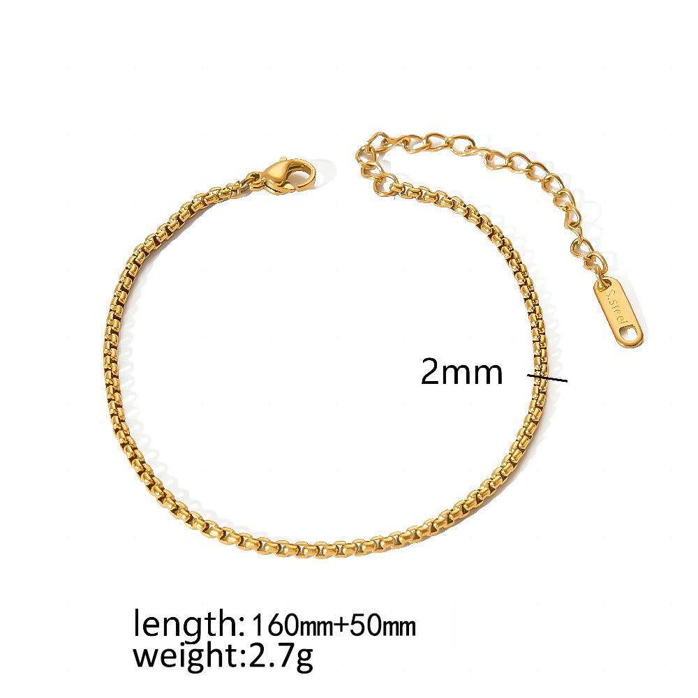 Close-up detail of a gold minimalist stainless steel bracelet with adjustable chain, emphasizing its stylish features.