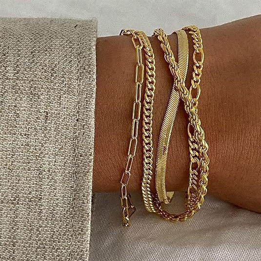 Lifestyle shot of a gold bracelet set on the wrist, showcasing elegant layering and minimalist design.