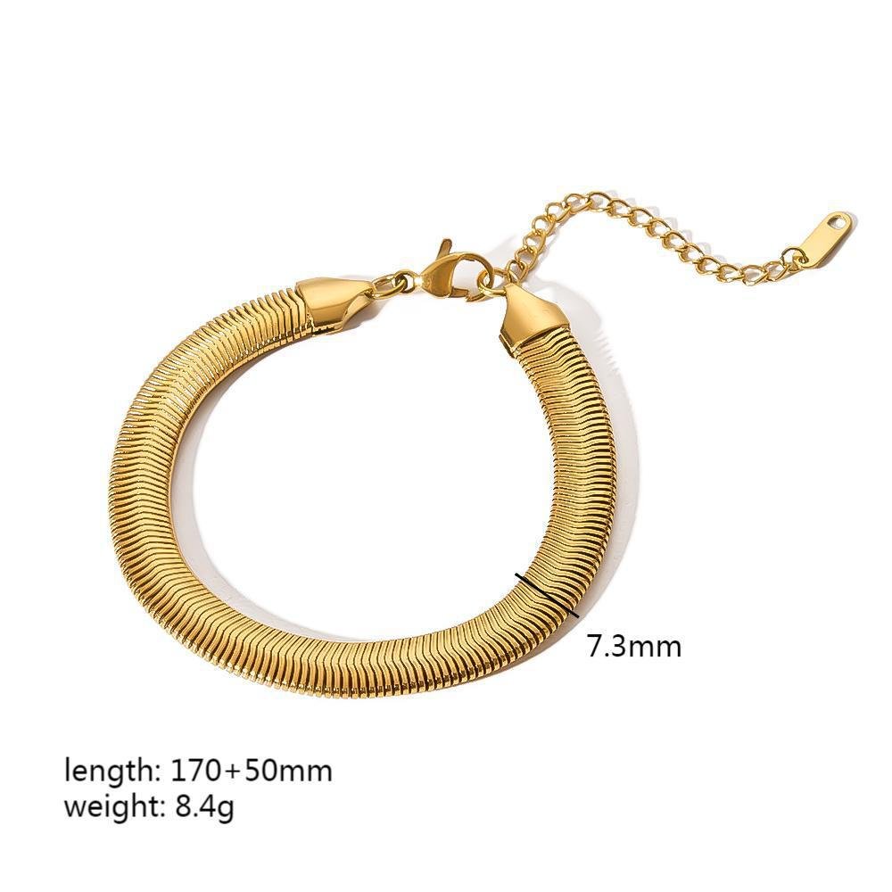 Detail shot of a textured gold minimalist stainless steel bracelet, emphasizing its chic design.