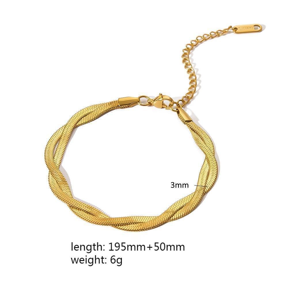 Detail shot of a twisted gold minimalist stainless steel bracelet, highlighting its unique design.