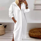 Long white polyester dress with collared neck and long sleeves, styled in a natural setting.