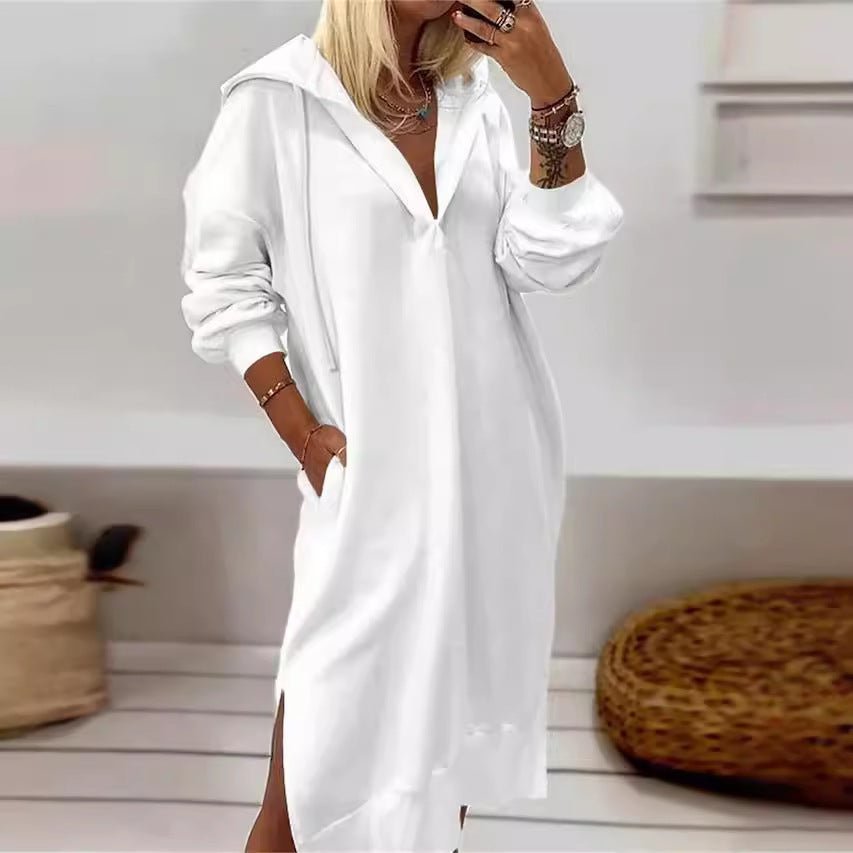 Long white polyester dress with collared neck and long sleeves, styled in a natural setting.