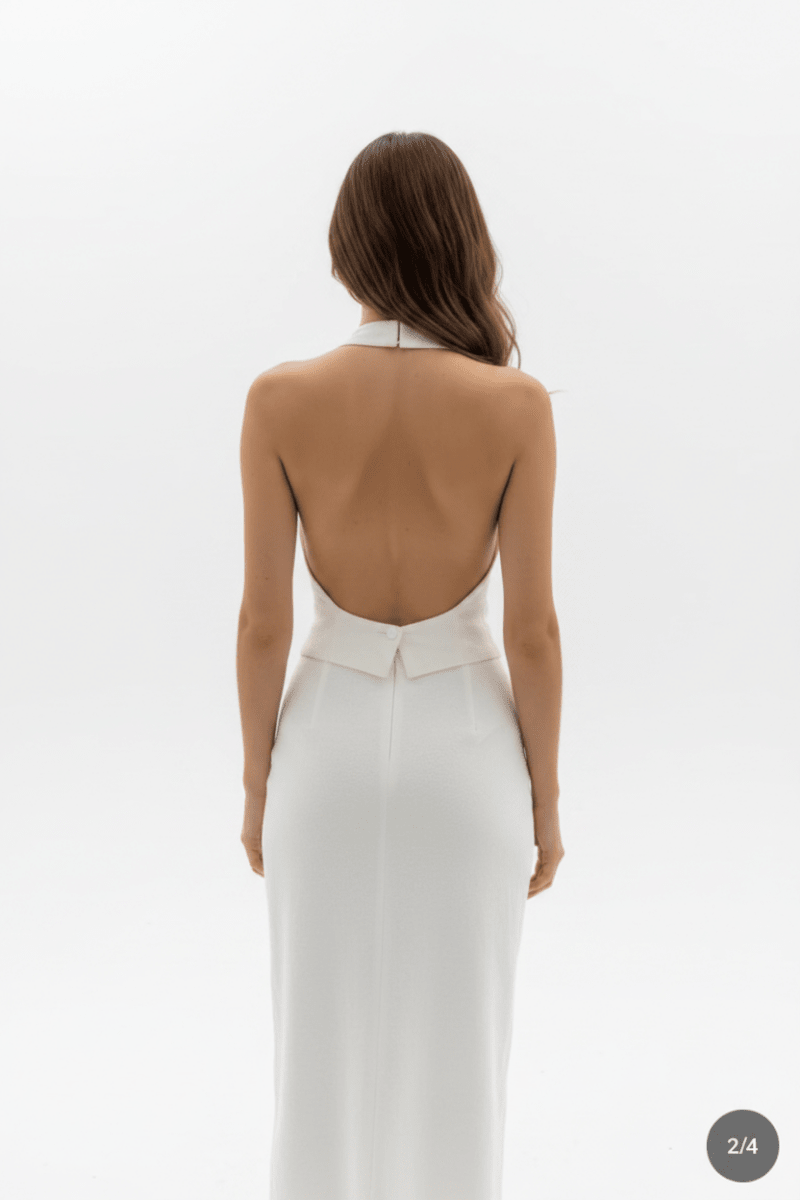 Back view of a white halter neck dress with button detail, elegant minimalist fashion @Black#White