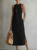 Elegant black halter neck dress showcasing lace patchwork and side slit in lifestyle setting.