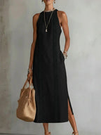 Elegant black halter neck dress showcasing lace patchwork and side slit in lifestyle setting.