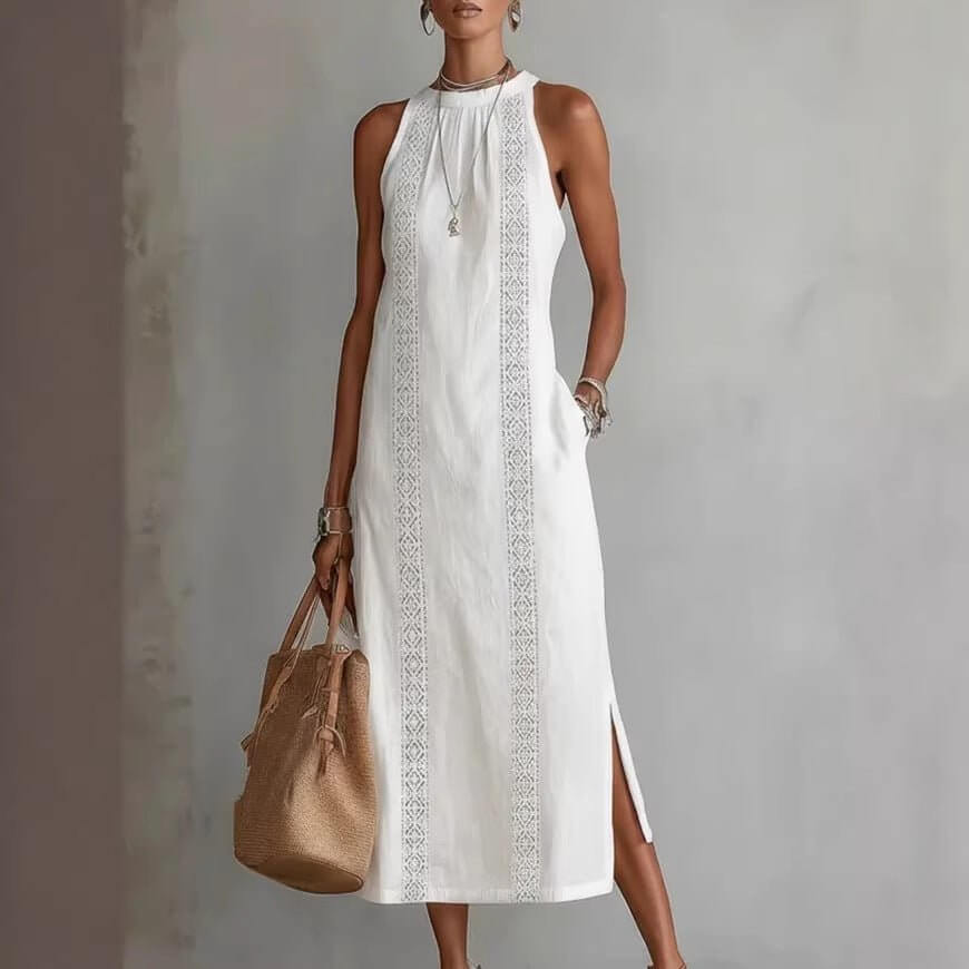 Stylish white halter neck dress featuring lace patchwork and side slit in lifestyle shot.