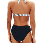 Lifestyle shot of the black bikini set featuring a halter neck and push-up design, perfect for summer.