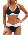 Front view of the black and white color block bikini set with halter neck and push-up features.