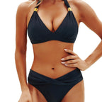 Front view of the chic black bikini set with halter neck and gold accents, perfect for resort wear.