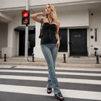 Lifestyle shot of black halterneck sleeveless top, showcasing slim fit with chic blue accents.