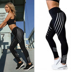 Side view of black high-waist leggings with a striped pattern, emphasizing the sporty aesthetic.