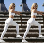 Lifestyle shot of a woman in white high-waist leggings, showcasing a chic sporty style in a natural setting.