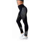 Detail close-up of black high-waist leggings with a striped pattern, highlighting the fabric texture.