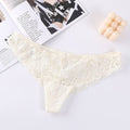 Detail view of cream lace mesh briefs highlighting lace design and ruffled edges.