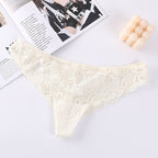 Detail view of cream lace mesh briefs highlighting lace design and ruffled edges.