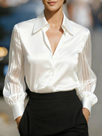 Lifestyle shot of a white satin long sleeve blouse, loose fit, chic minimalist design @Black#White