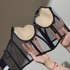 Lifestyle view of a black push-up bra featuring mesh fabric and underwire, styled elegantly in a natural setting.