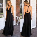 Long black bandage maxi dress featuring v-neck and cross back in a lifestyle shot, perfect for elegant occasions.
