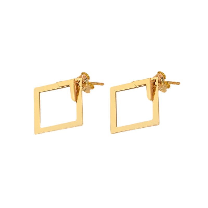 Detail close-up of gold geometric earrings with square shape, highlighting geometric design.