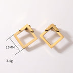 Detail close-up of gold geometric earrings with square shape, showcasing geometric design.