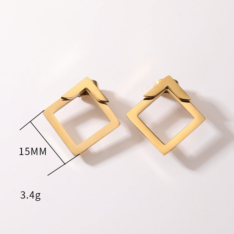 Detail close-up of gold geometric earrings with square shape, showcasing geometric design.