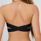 Back view of the black strapless tube bra showcasing cross back design and buckle closure, minimalist fashion