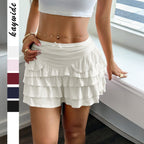 Lifestyle shot of a white tiered midi skirt with elastic waistband, showcasing chic summer style @Black#White