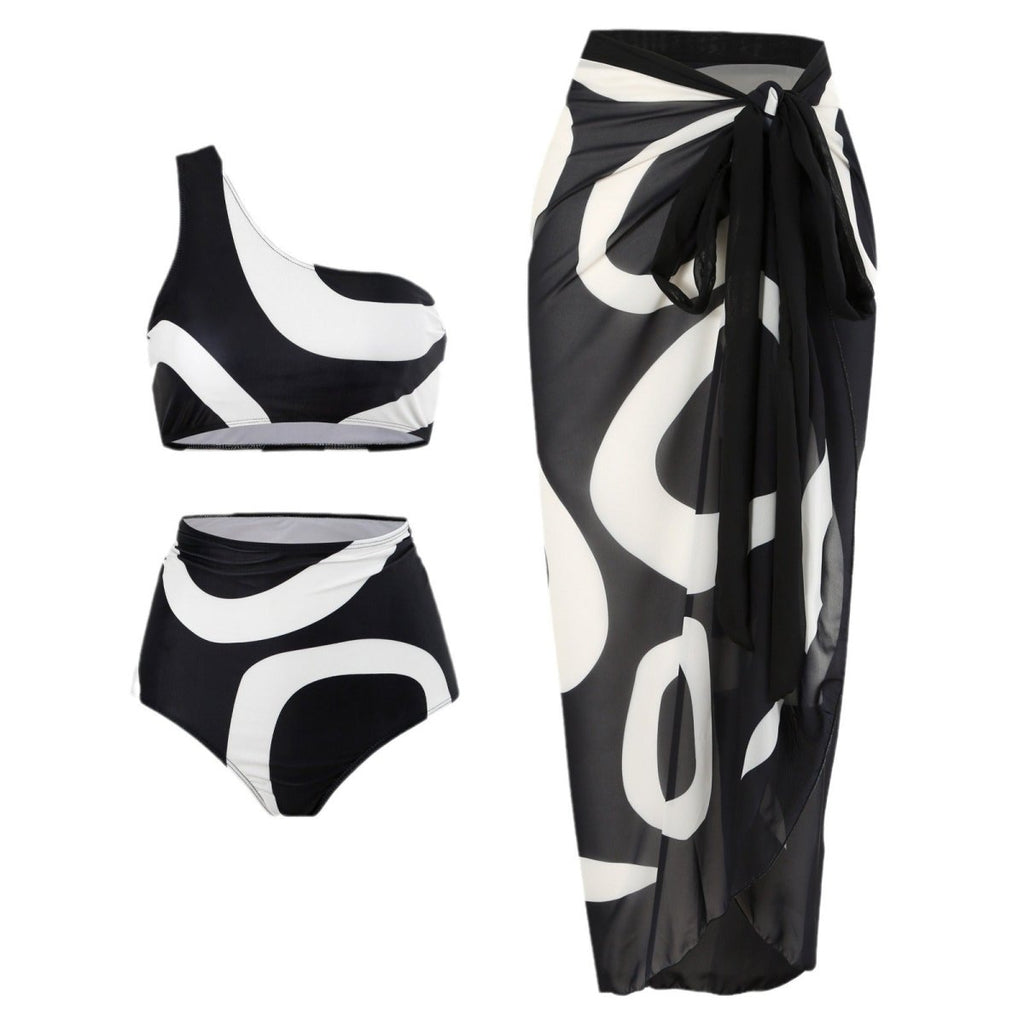Bikini with wrap skirt featuring one-shoulder design on a white background, showcasing chic beachwear.