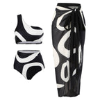 Bikini with wrap skirt featuring one-shoulder design on a white background, showcasing chic beachwear.