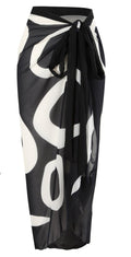 Side view of black wrap skirt with tie closure and abstract pattern, emphasizing stylish details.