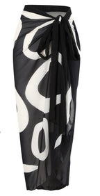 Side view of black wrap skirt with tie closure and abstract pattern, emphasizing stylish details.