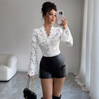 Lifestyle shot of a white lace bodycon top, featuring delicate lace detail and long sleeves against a natural background.