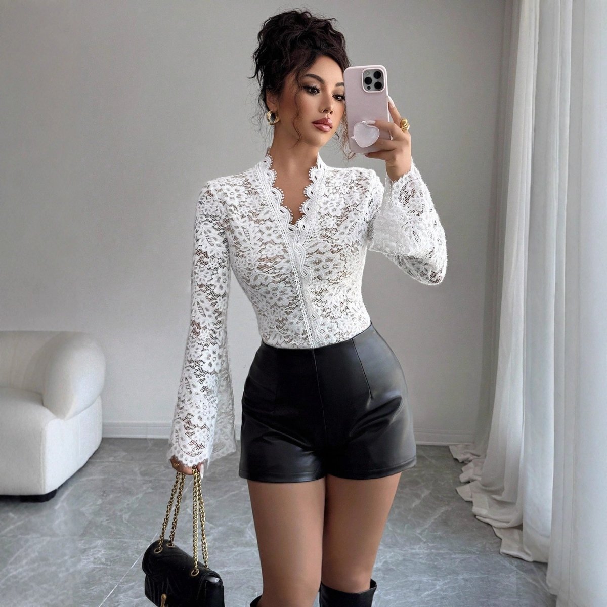 Lifestyle shot of a white lace bodycon top, featuring delicate lace detail and long sleeves against a natural background.