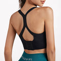 Back view of the black open back sports bra, highlighting its chic cross strap feature.