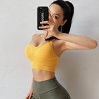 Lifestyle shot of the yellow open back sports bra, featuring adjustable straps and a stylish design.