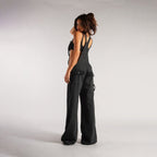 Back view of black loose denim overalls emphasizing the high waist design and wide leg cut, a trendy addition to any wardr…
