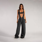 Front view of black loose denim overalls featuring a high waist design and wide legs, perfect for a chic outfit.